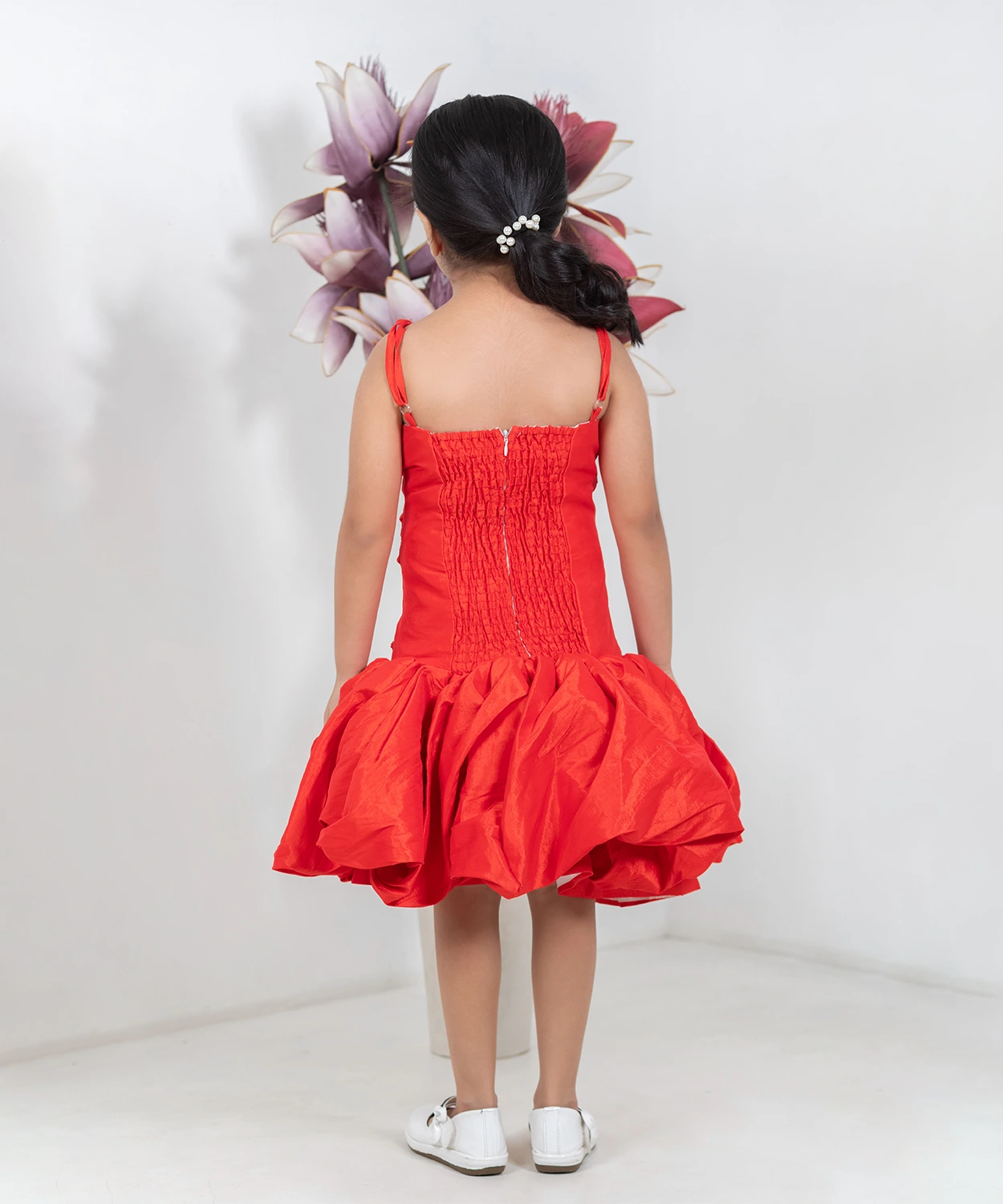 A Shimmery Orange Dress With A Unique Silhouette